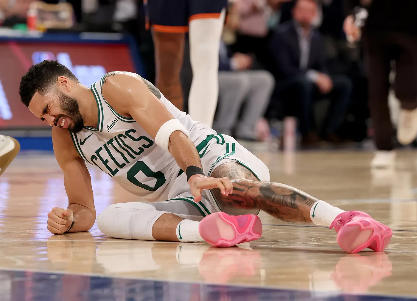Jayson Tatum injured on court during NBA game.